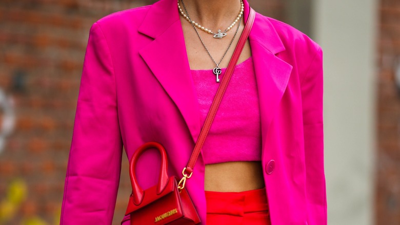 Woman in pink outfit and necklace