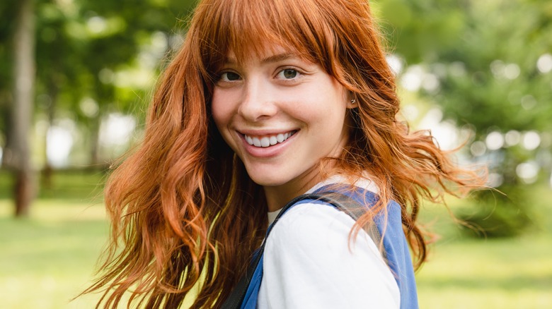 A woman smiling at the park