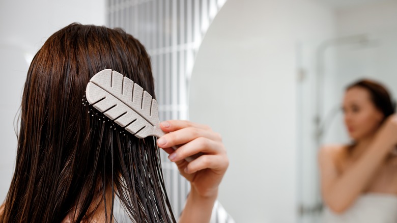 woman combing wet hair 