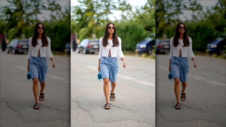 Woman wearing long jorts, cardigan 