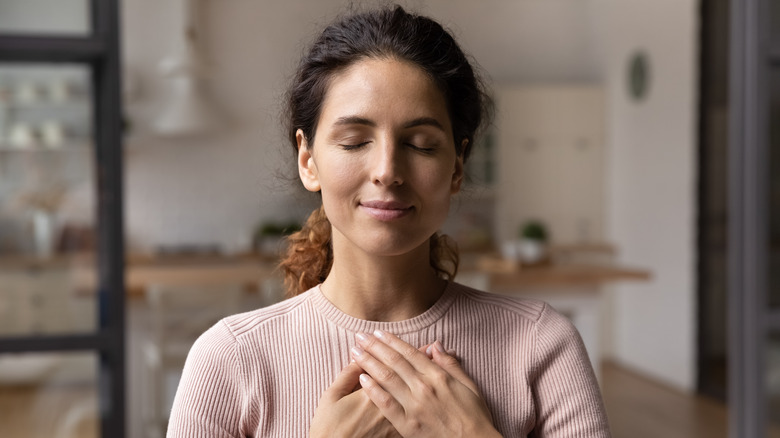 Woman meditating and choosing positive thoughts