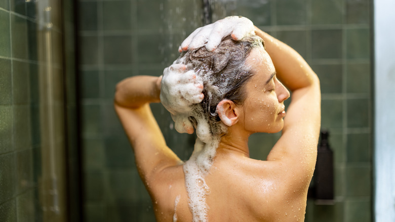 Woman washing hair in shower