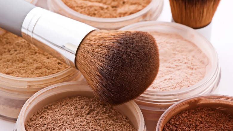 close-up of kabuki brush over powders