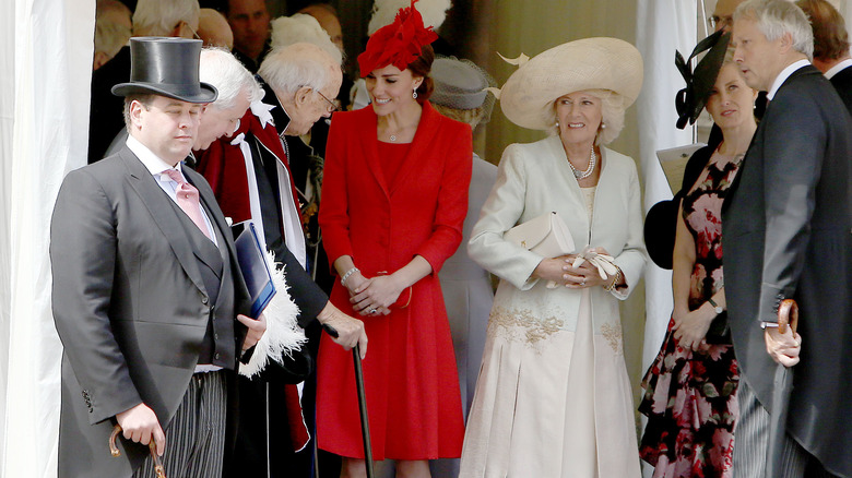 Kate Middleton smiling in red dress
