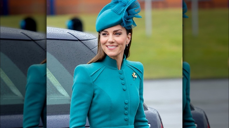 Kate Middleton smiling in teal outfit