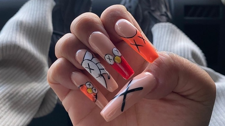 hand with KAWS nail art