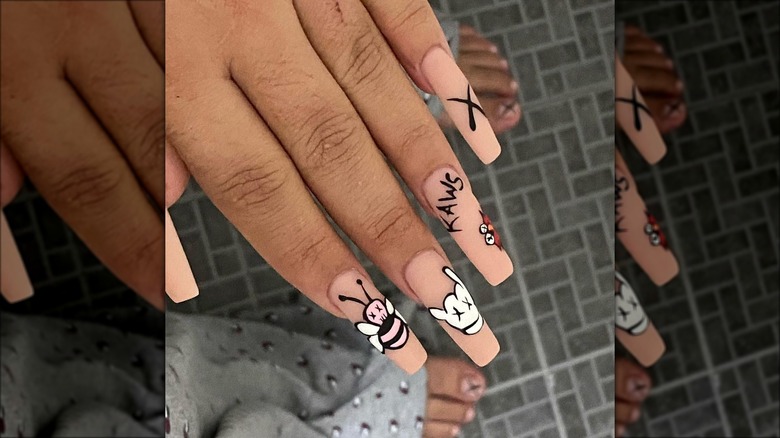 hand with KAWS nail art