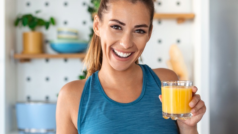 woman with orange juice smiling