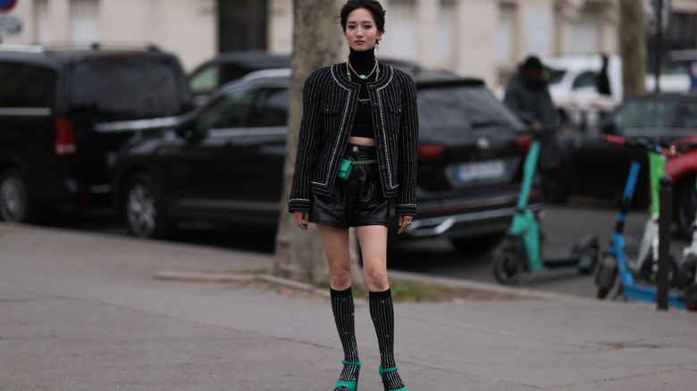 woman wearing embellished knee-high socks