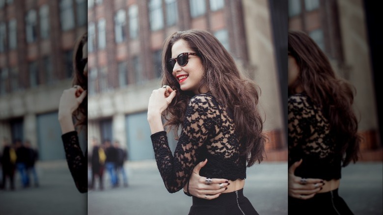 Woman wearing all lace sheer black top 