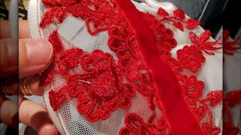 Person hand-stitching lace garment