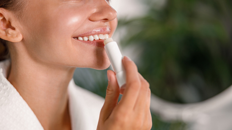 Woman applying lip balm