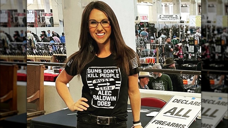 Lauren Boebert posing in a "Guns Don't Kill People, Alec Baldwin Does" t-shirt