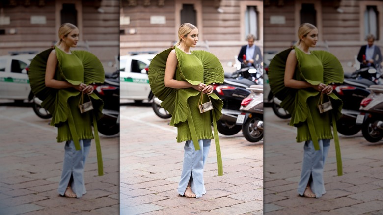 woman wearing green dress over jeans