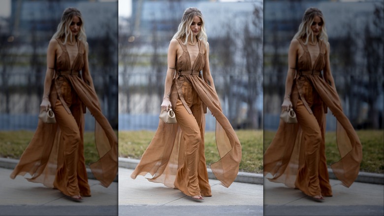 woman wearing camel dress over pants