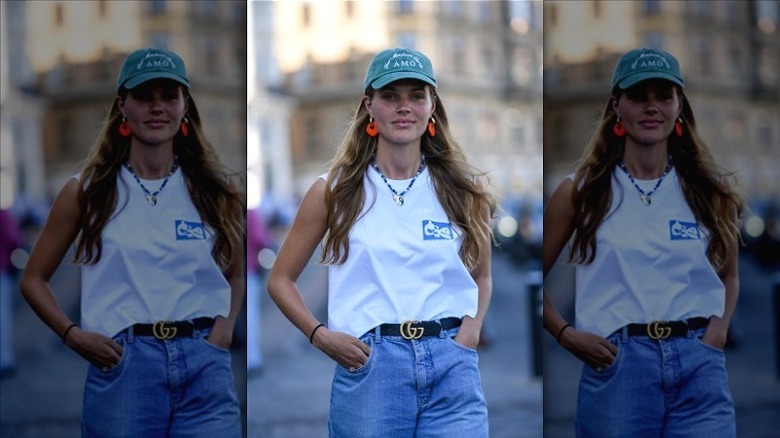 woman with wavy hair andcap 