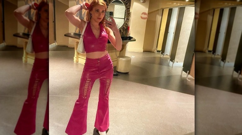 Girl wearing a coordinating pink leather set.