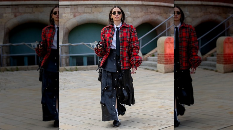 Woman with leather skirt and checkered jacket