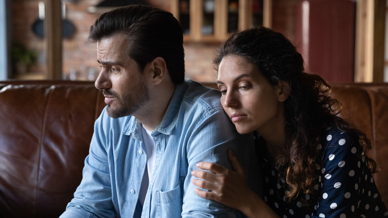 woman comforting man