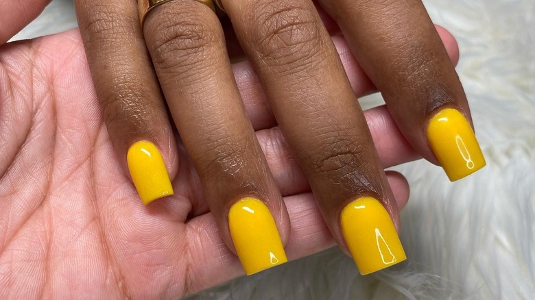 close up of shiny yellow nails