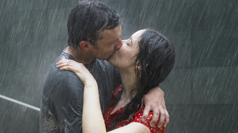 People kissing in the rain