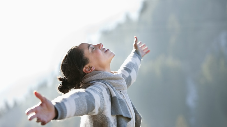 Woman outstretching her arms