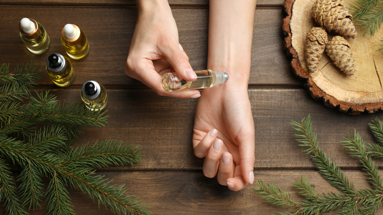 woman puts scent on wrist