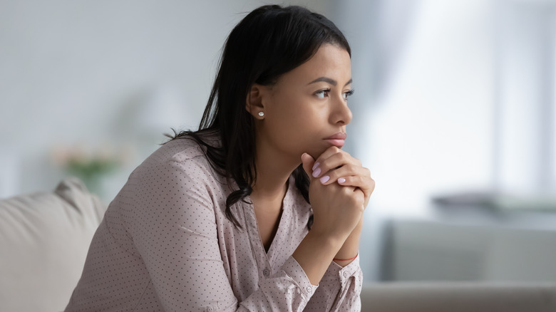 Worried young woman on couch