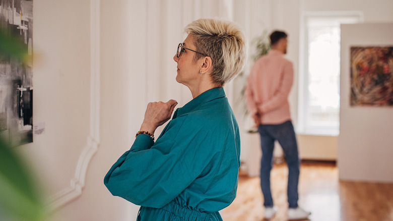 Woman looking at photo in art gallery