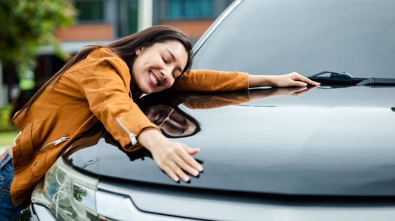 woman hugging new car
