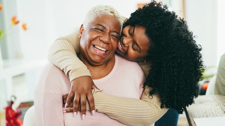 Two women hugging, smiling