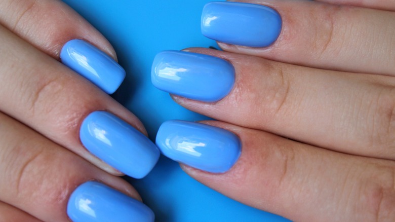 Hands with sky blue manicure