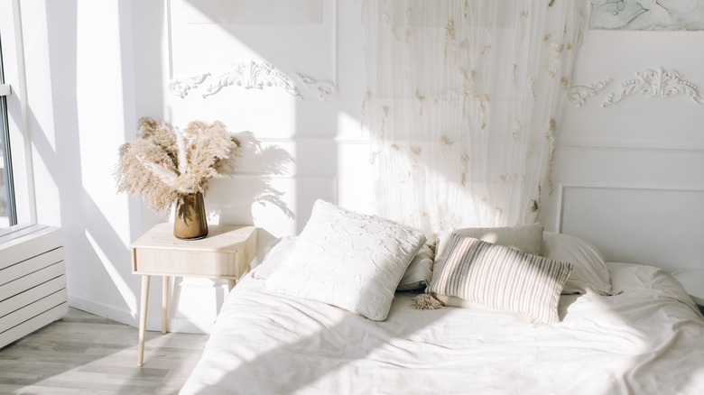 white bedroom with sun pouring into the room