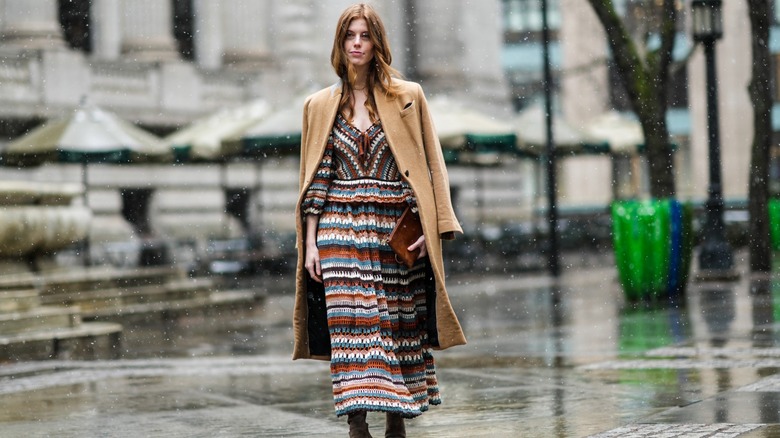 Woman wearing crochet dress, coat