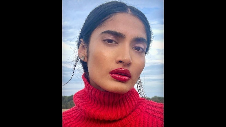 woman wearing red lip gloss