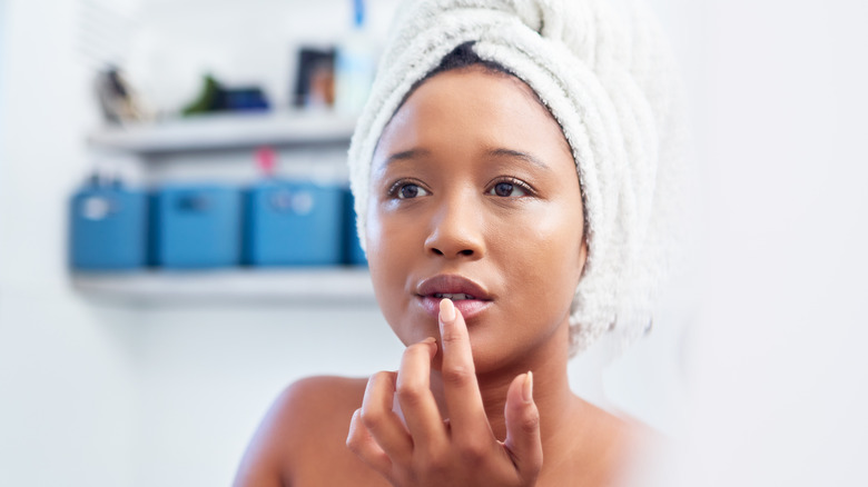 Woman applying lip mask