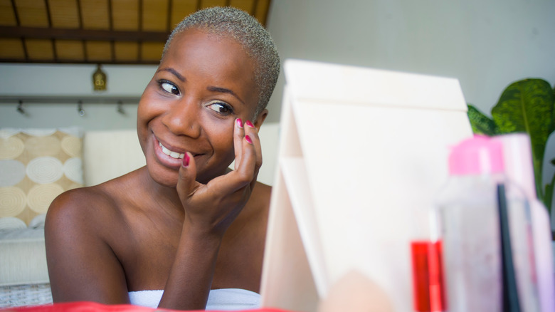 woman applying makeup using fingers