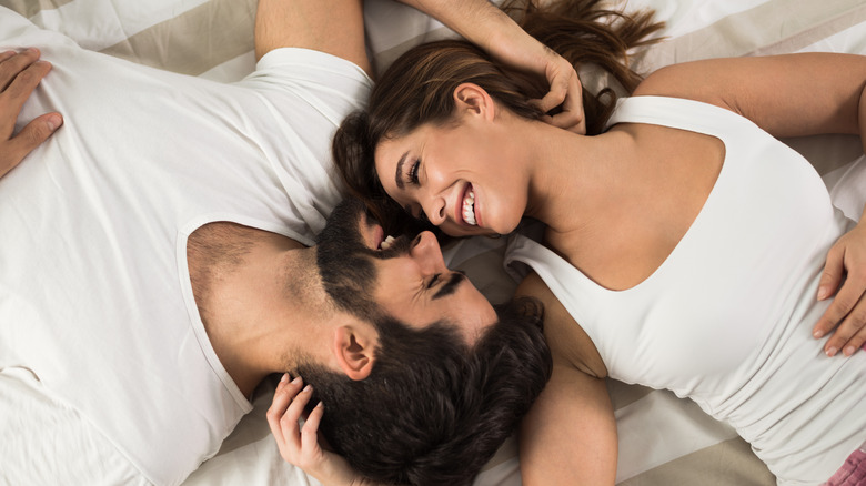 smiling couple on bed