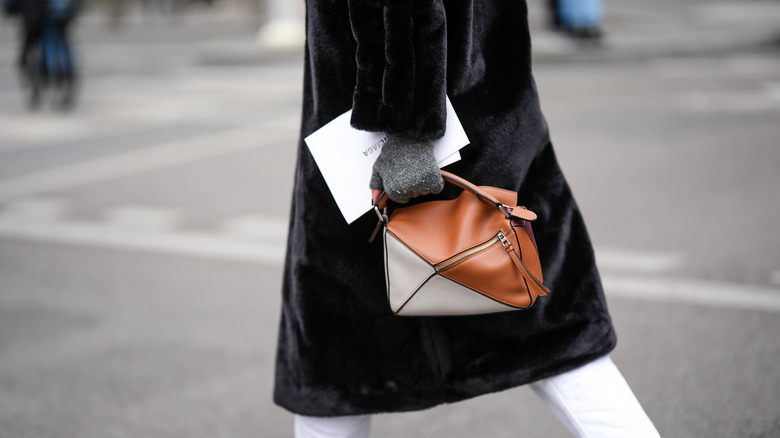 Woman walking, holding Loewe bag