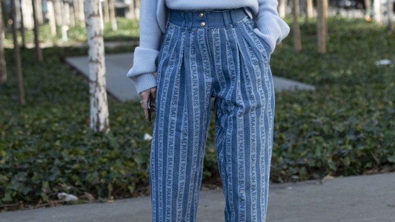 woman wearing Balmain printed jeans