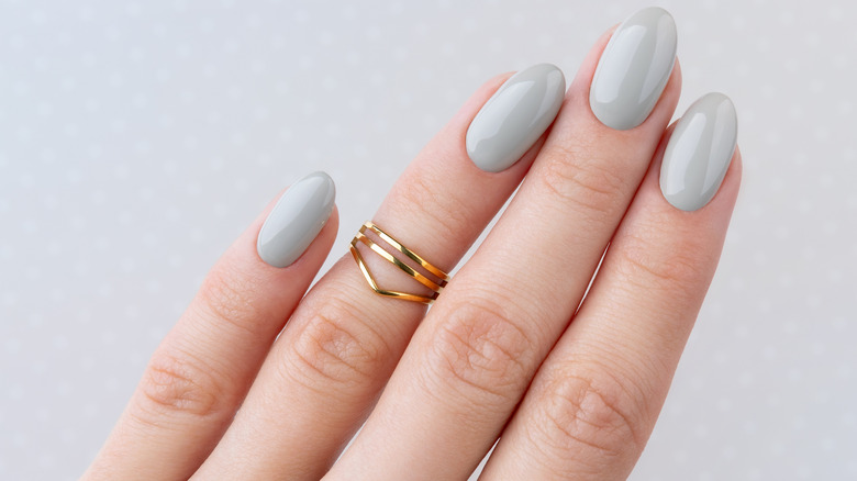 Hand showcasing pale gray manicure 