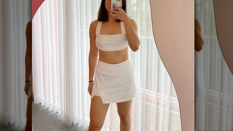 woman wearing white crop top skort