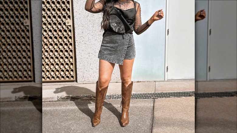 woman wearing denim skort cowboy boots