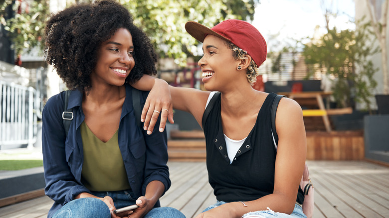 women smiling at each other