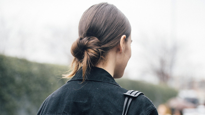 Woman with a low messy bun