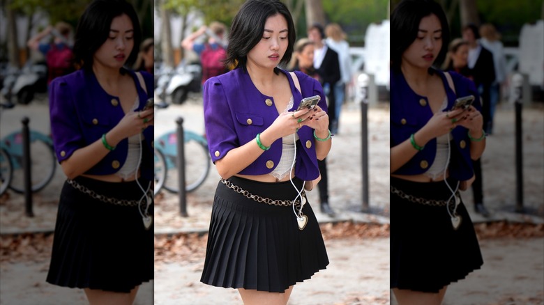 Woman wearing cropped purple blazer and skirt