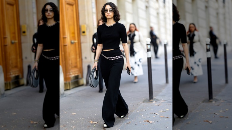 Woman wearing black outfit with chain belt