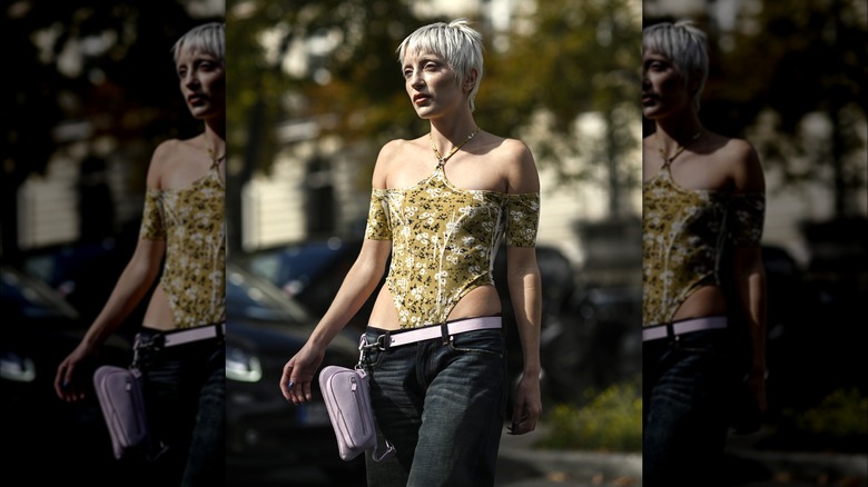 Woman wearing corset and low-rise jeans