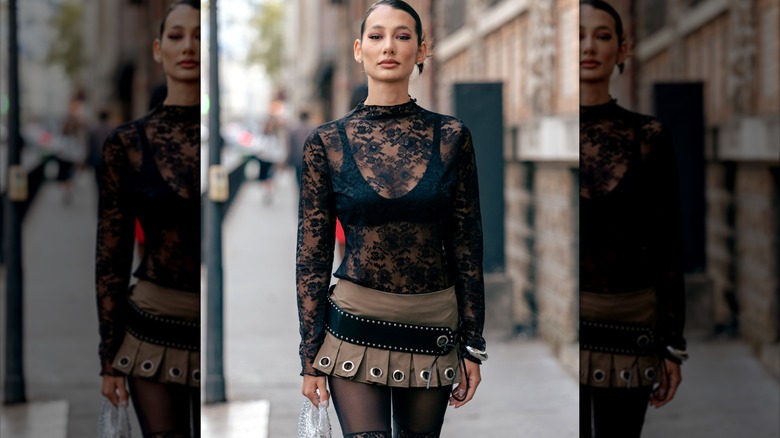 Woman wearing lace top and pleated skirt