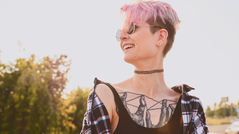 pink-haired person with chest tattoo